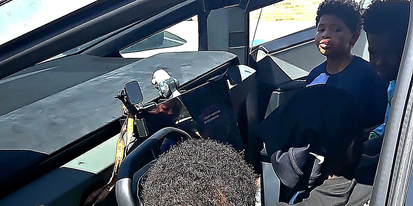 Students gathered around a Cybertruck during the CBC camp conclusion, looking at the vehicle interface and celebrating camp progress