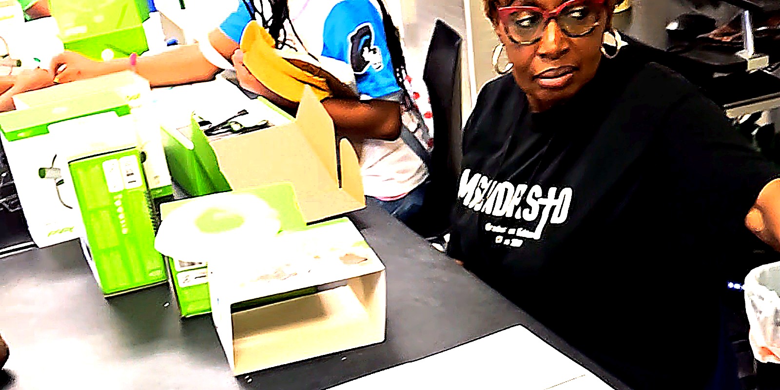 CBC camp students inside a Cybertruck, engaged and listening during the camp celebration