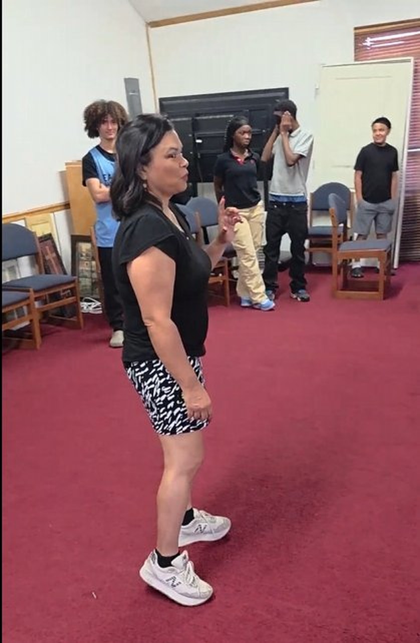 Norma Weems working with students in a classroom roleplay